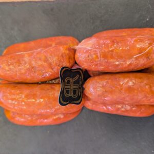 Saucisses fraîches artisanales attachées sur fond sombre